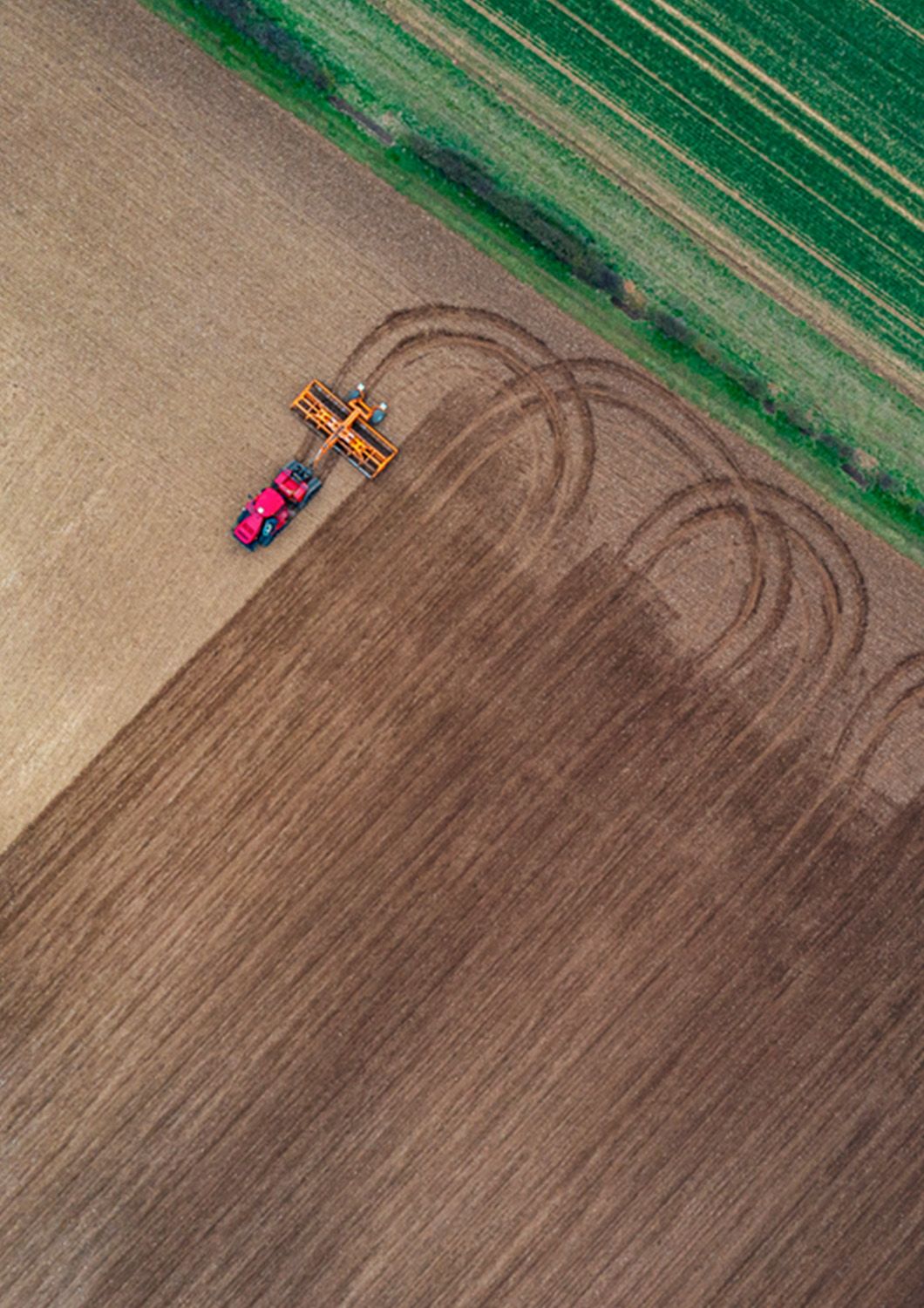 Drone view of tractor ploughing a field