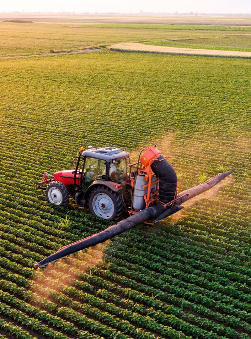 Tractor spraying soybean field