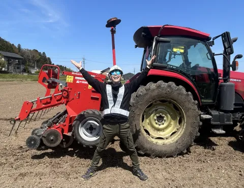 Farmer Tokumoto standing in front of of his tractor, Japan