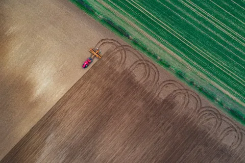 Drone view of tractor ploughing a field